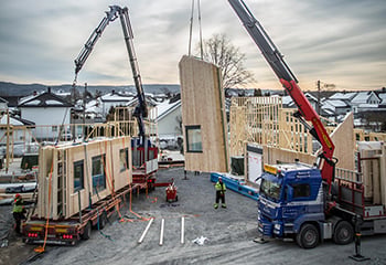 Off-site construction with trucks and cranes