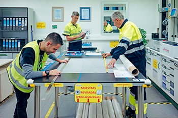 Three workers during product quality analysis