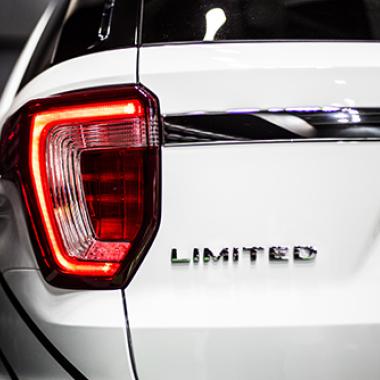 Rear stop light of large SUV car with emblem