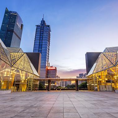 Illuminated modern building exterior and empty street.