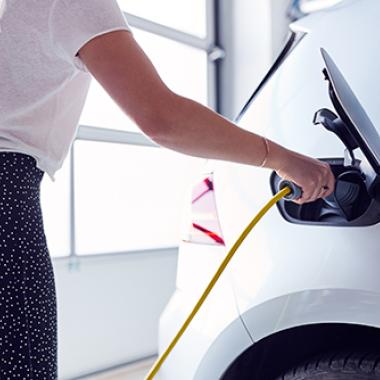 Woman charging an electric car.