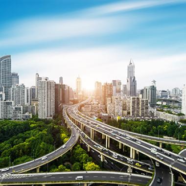 An elevated city overpass featuring skyscrapers and a highway traffic system