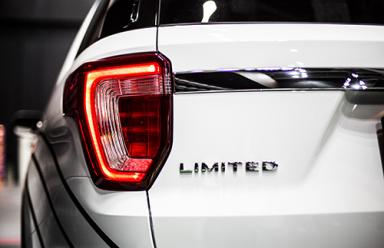 Rear stop light of large SUV car with emblem