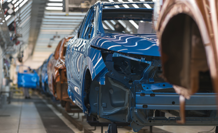 Blue and red car chassis on a production line.