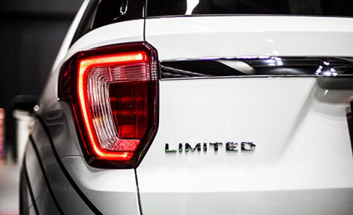 Rear stop light of large SUV car with emblem