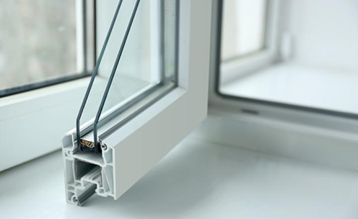 A white windowsill profile with glass panes and vinyl aluminum corner.