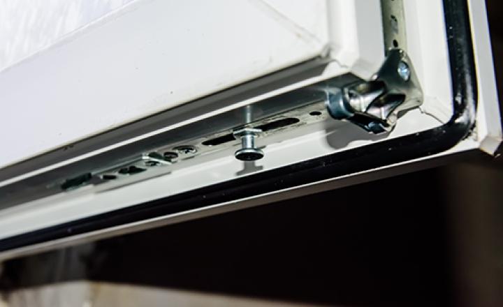 Close up of a corner glaze framework with aluminum panels and glass.