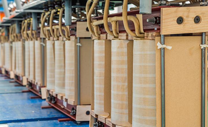 Oil immersed transformers with active parts of cores and coils in a production line.