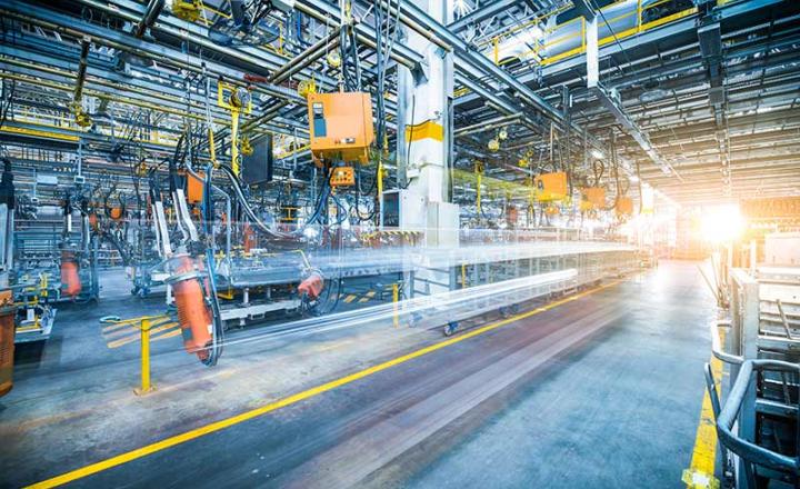Robots welding car inside an automotive assembly factory