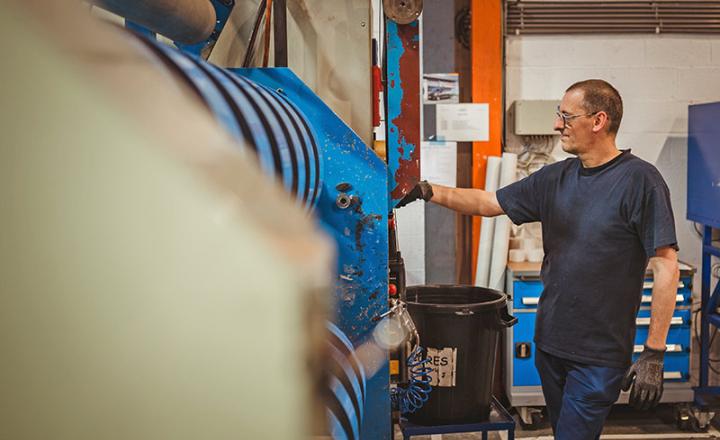 Manufacturing factory plant worker examining tape roll configurations