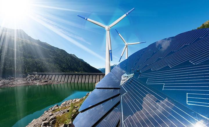 Solar panels in sunlight, wind turbines and a damn with hydropower for renewable energy