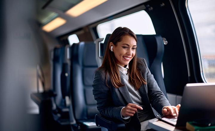 A businesswoman working with a computer during travelling in a modern train.