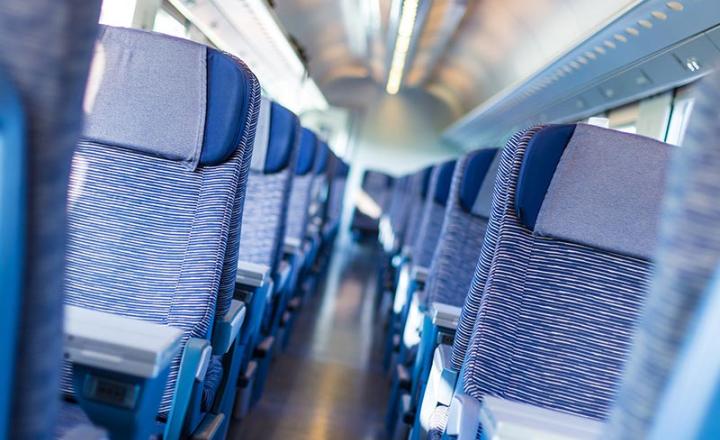 Economy class fast train featuring rows of blue seats