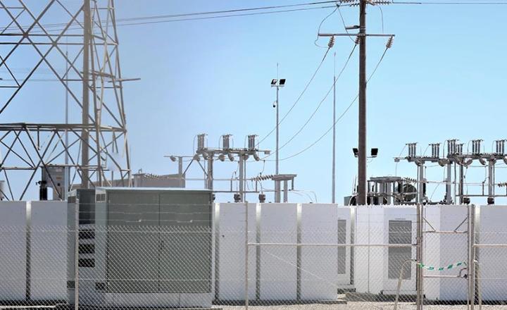 Battery storage power station accompanied by solar and wind turbine power plants.