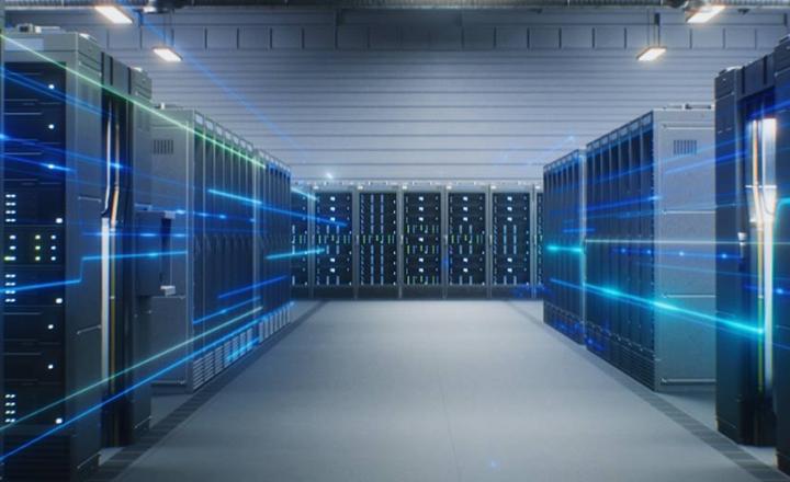 A data center with multiple server racks in a futuristic warehouse.