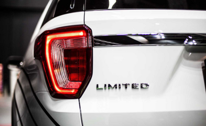 Emblem on SUV rear using acrylic bonding tape.