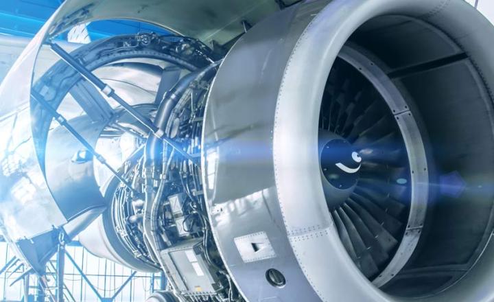 The engine of an aircraft with opened side and structures for maintenance in the hangar.