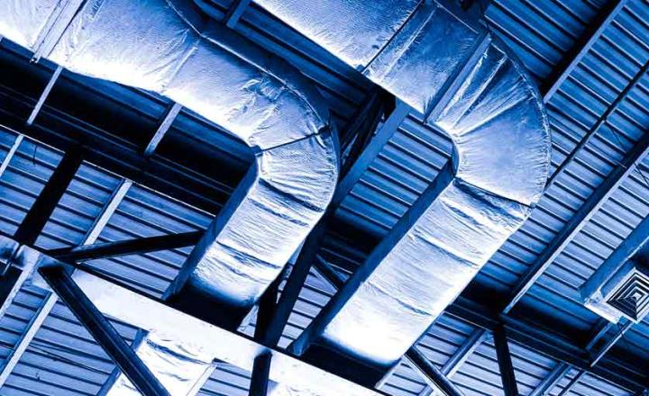 Isolated heating and ventilation lines under the metal ceiling of a building