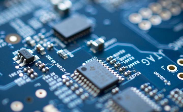 Detail of blue electronic microchip circuit board with blurred edges.
