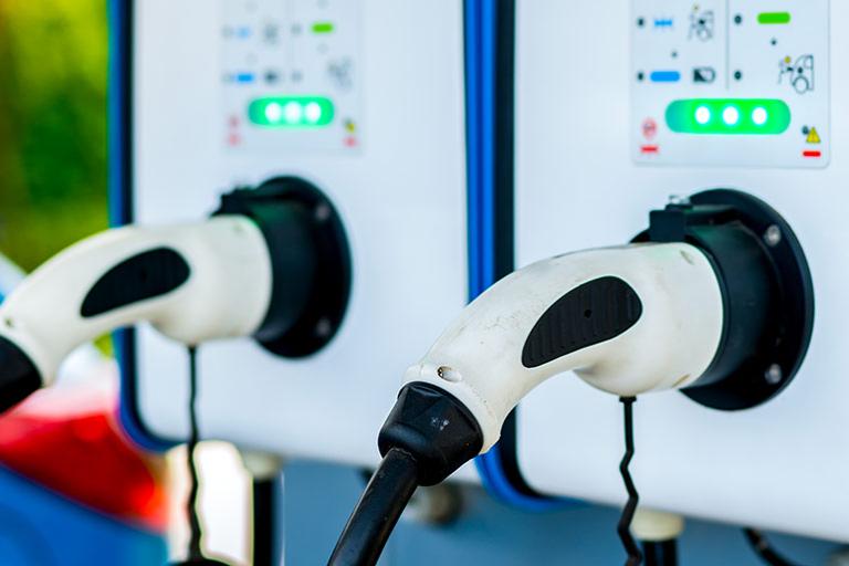 Electric car charging station, with two plugs, for charging the EV battery of a hybrid vehicle.