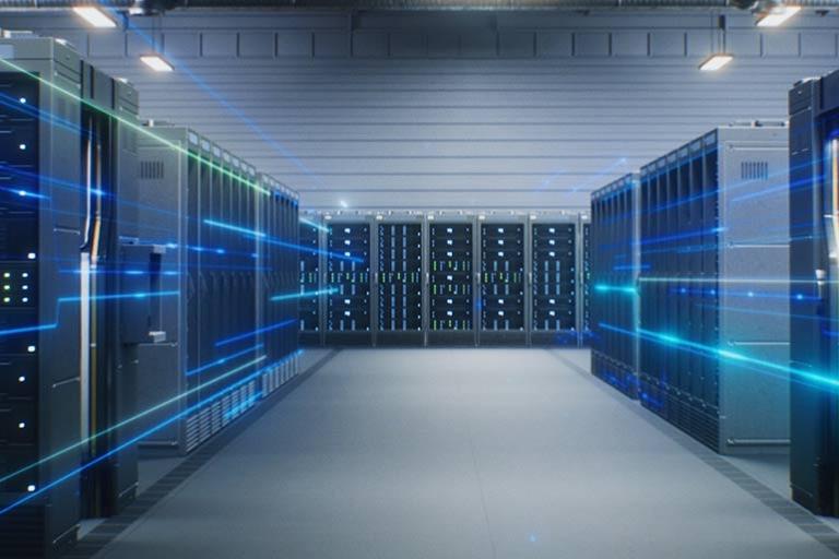 A data center with multiple server racks in a futuristic warehouse.