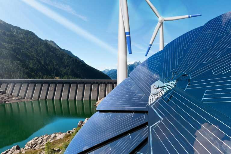 Hydro-power dam with solar panels and wind turbines against mountains and blue sky