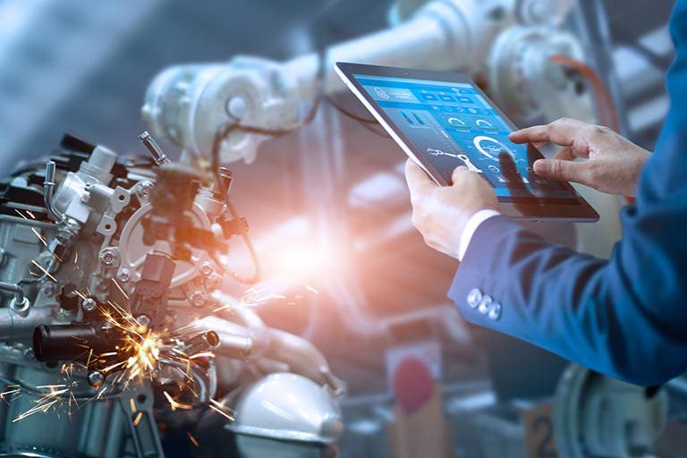 Manager engineer check and control automation robot arms machine in intelligent factory industrial on real time monitoring system software.