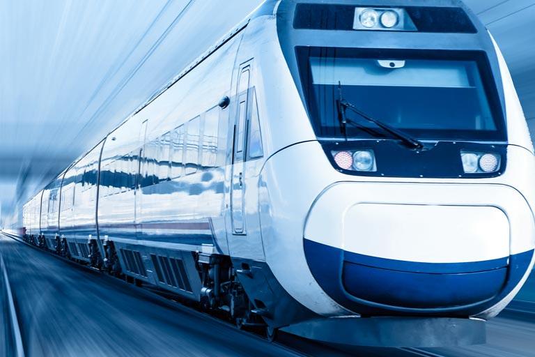 Fast-moving white train with blue background.