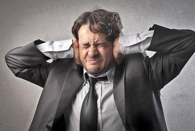 A man covering his ears to protect from noise
