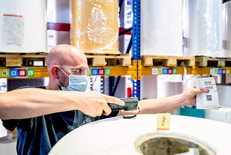 A Saint-Gobain® Tape Solutions employee preparing materials for a customer order