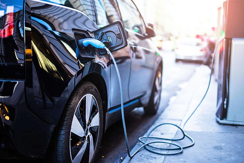 An electric vehicle using fast-charging options at a public charging station