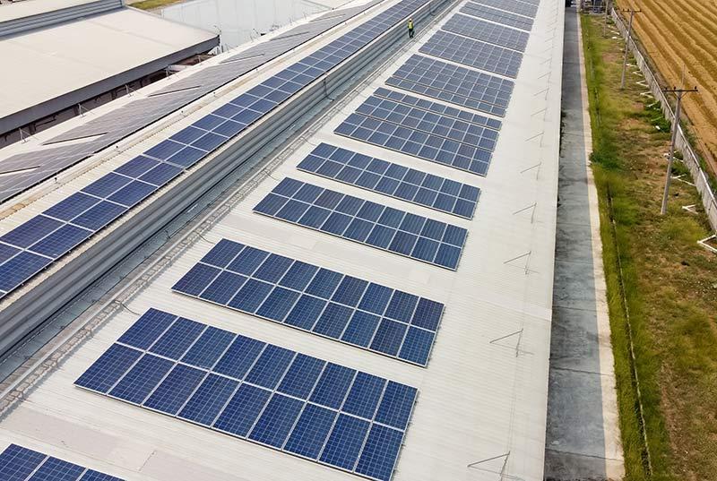 Photovoltaic solar panels and PV modules mounted on a flat roof.