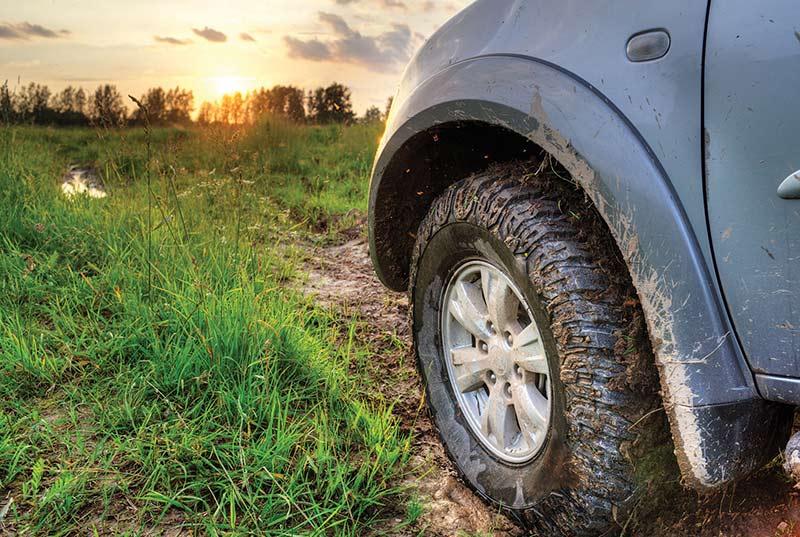 A sport utility vehicle on a muddy road.