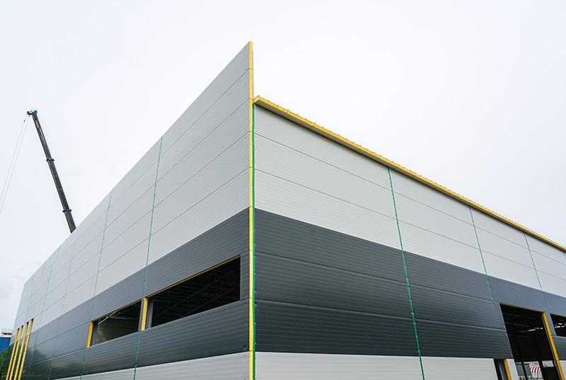 New modern two tone gray sandwich panel industrial building facade.