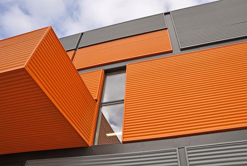 Wall of the modern orange and black corrugated metal panels.
