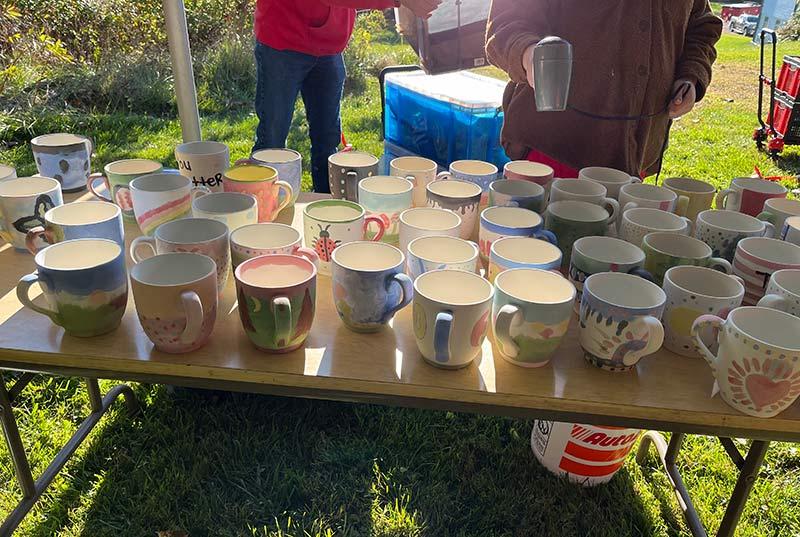 HicksStrong Hug Mugs 2024 on table