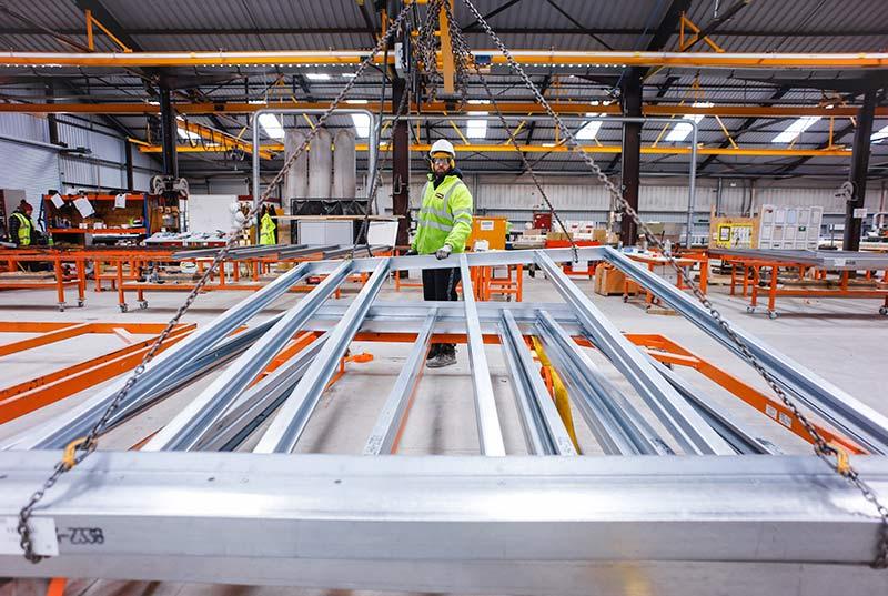 Handling prefabricated elements inside a manufacturing facility