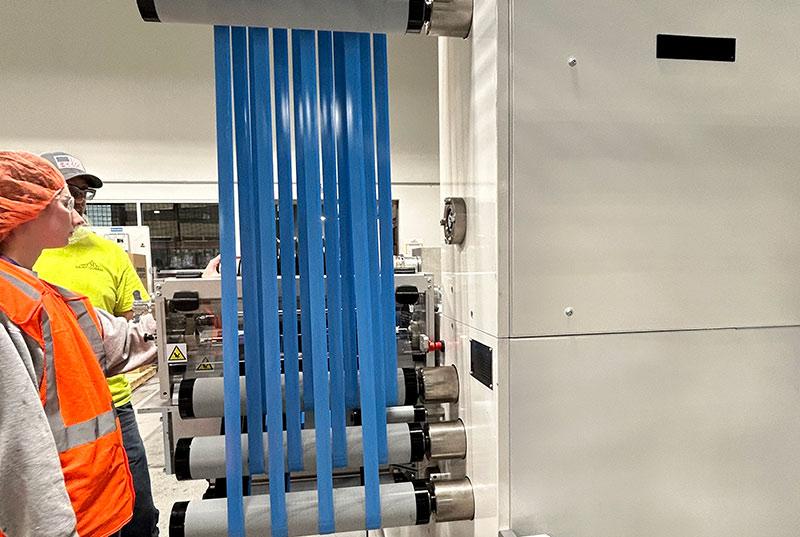 Engineers observing spooling tape equipment