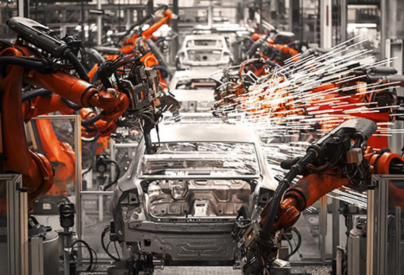 Robotic arms sparking on an automobile production assembly line