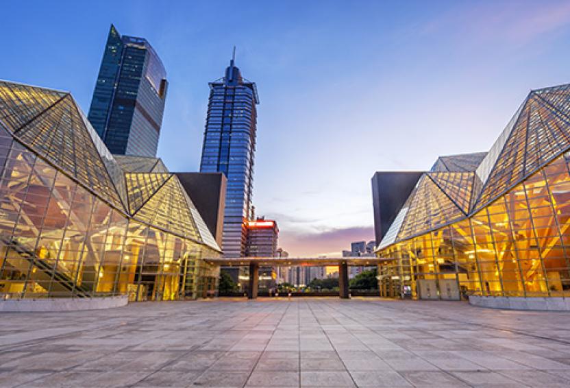 Illuminated modern building exterior and empty street.